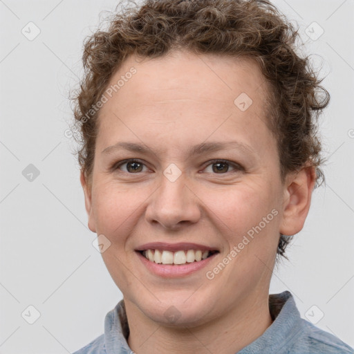 Joyful white young-adult female with short  brown hair and grey eyes