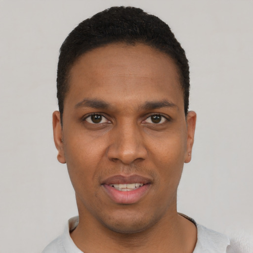 Joyful black young-adult male with short  black hair and brown eyes