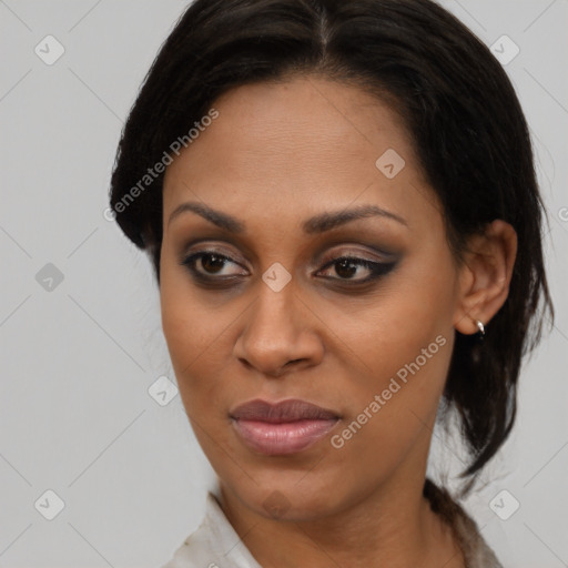 Joyful black adult female with medium  brown hair and brown eyes