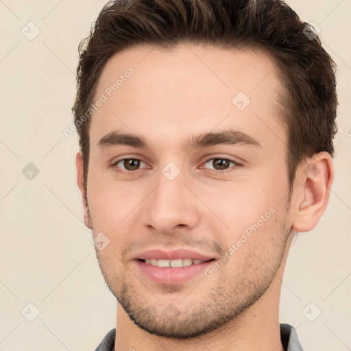 Joyful white young-adult male with short  brown hair and brown eyes