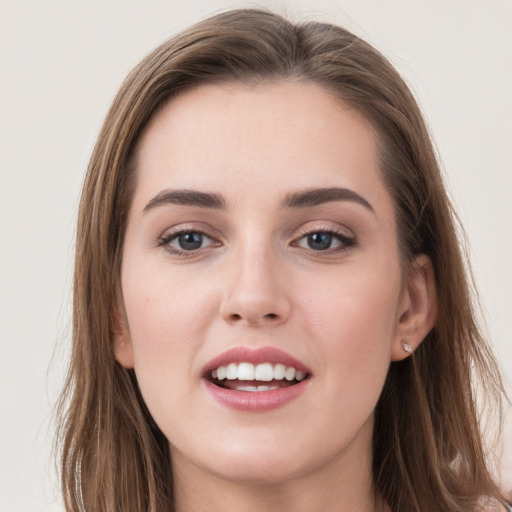 Joyful white young-adult female with long  brown hair and grey eyes