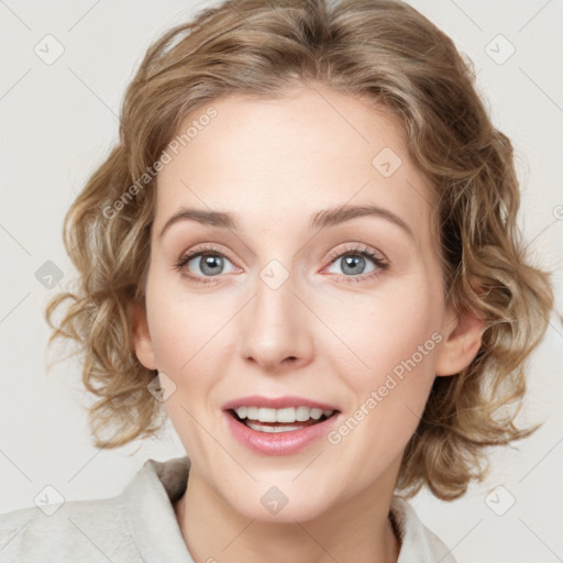 Joyful white young-adult female with medium  brown hair and blue eyes