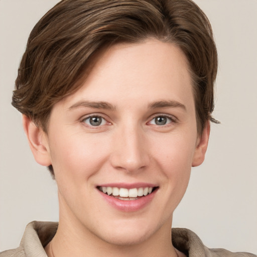 Joyful white young-adult female with short  brown hair and grey eyes