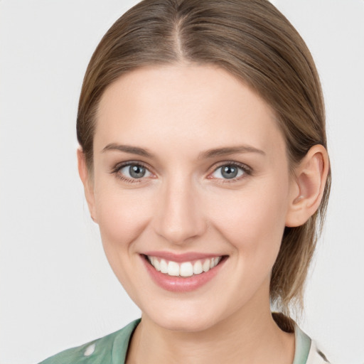 Joyful white young-adult female with medium  brown hair and grey eyes