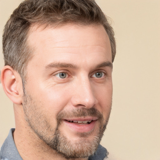 Joyful white adult male with short  brown hair and grey eyes