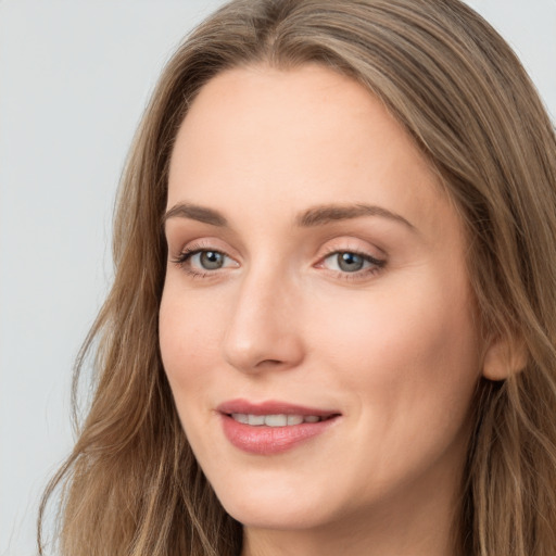 Joyful white young-adult female with long  brown hair and grey eyes