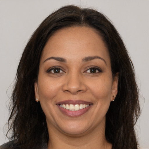 Joyful white adult female with long  brown hair and brown eyes