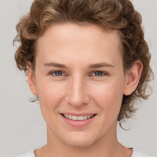 Joyful white young-adult female with medium  brown hair and blue eyes