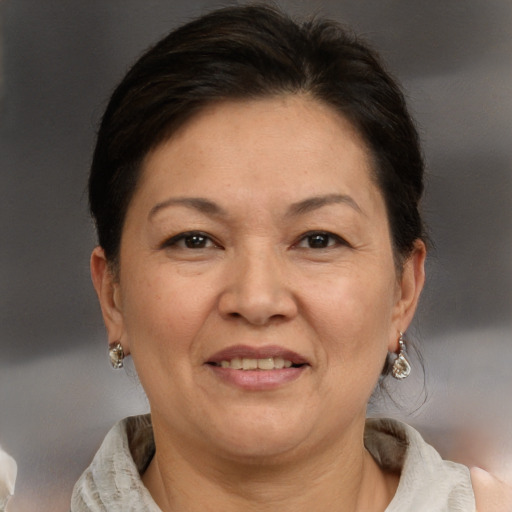 Joyful white adult female with short  brown hair and brown eyes