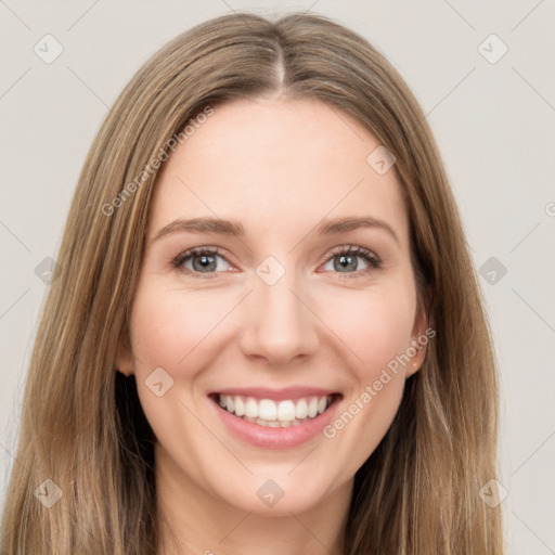 Joyful white young-adult female with long  brown hair and green eyes