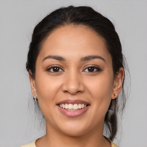 Joyful latino young-adult female with medium  brown hair and brown eyes