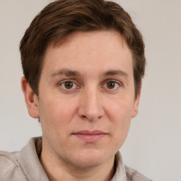 Joyful white adult male with short  brown hair and grey eyes