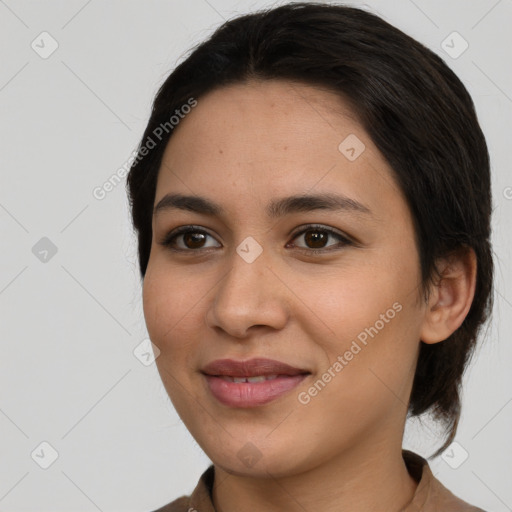 Joyful latino young-adult female with medium  brown hair and brown eyes