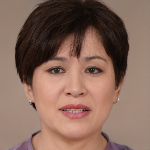 Joyful white adult female with medium  brown hair and brown eyes