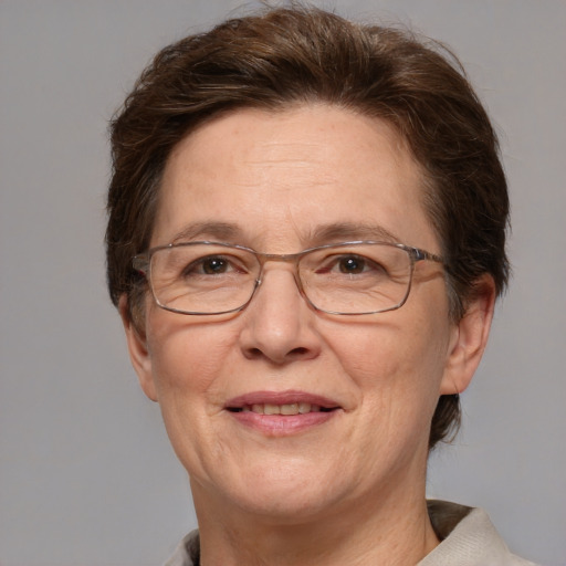 Joyful white middle-aged female with medium  brown hair and grey eyes