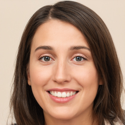 Joyful white young-adult female with medium  brown hair and brown eyes