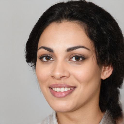 Joyful white young-adult female with medium  black hair and brown eyes
