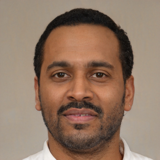 Neutral latino adult male with short  black hair and brown eyes