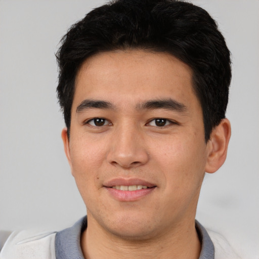 Joyful asian young-adult male with short  black hair and brown eyes