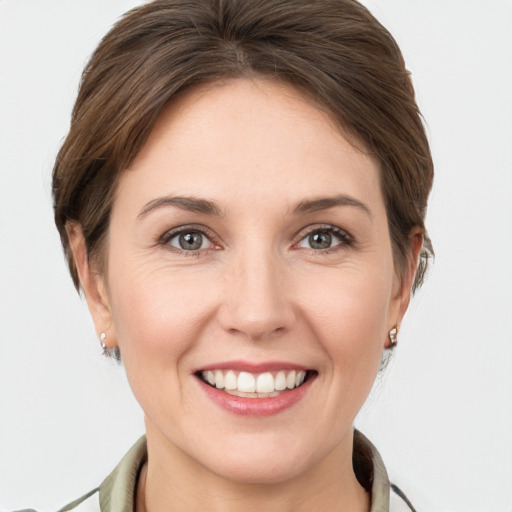 Joyful white young-adult female with short  brown hair and grey eyes