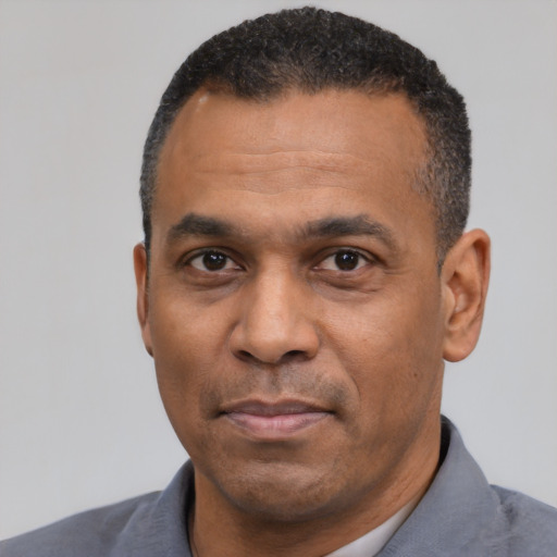 Neutral latino adult male with short  black hair and brown eyes