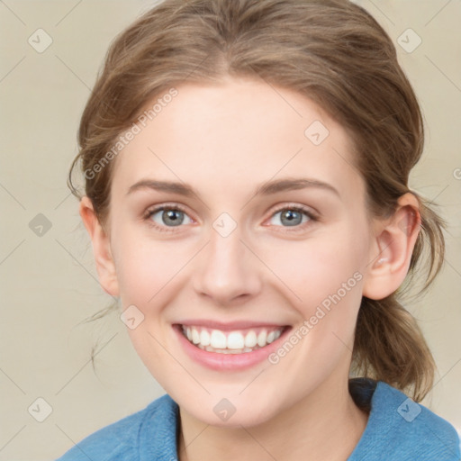 Joyful white young-adult female with medium  brown hair and blue eyes