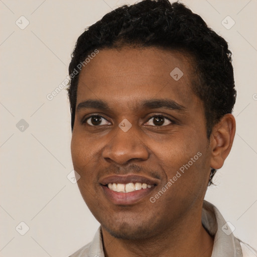 Joyful black young-adult male with short  black hair and brown eyes