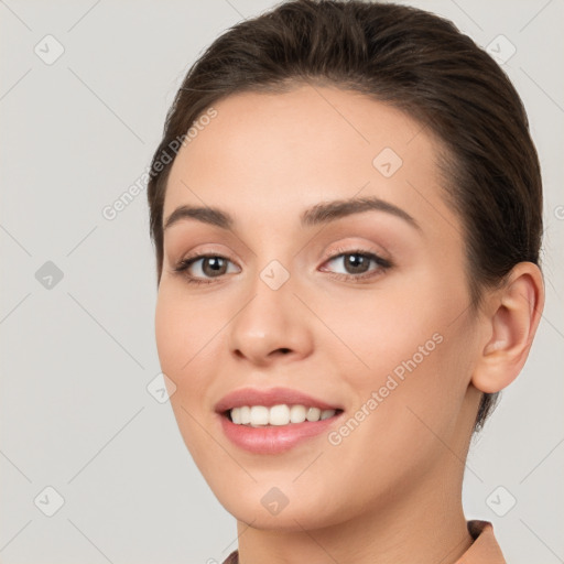 Joyful white young-adult female with long  brown hair and brown eyes