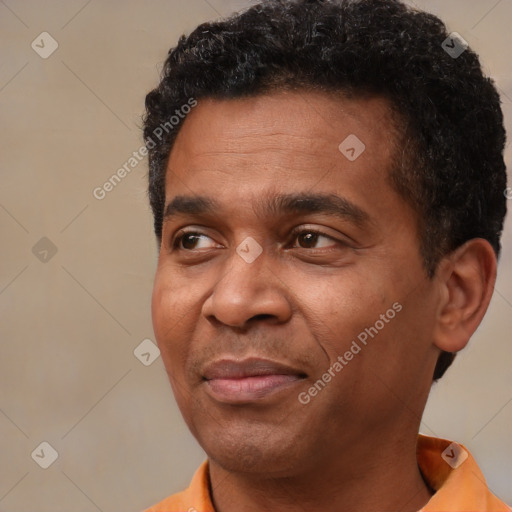 Joyful black adult male with short  brown hair and brown eyes