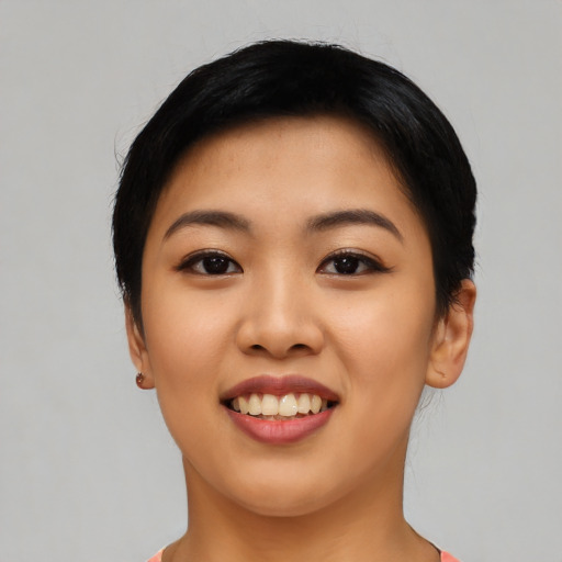 Joyful asian young-adult female with short  black hair and brown eyes
