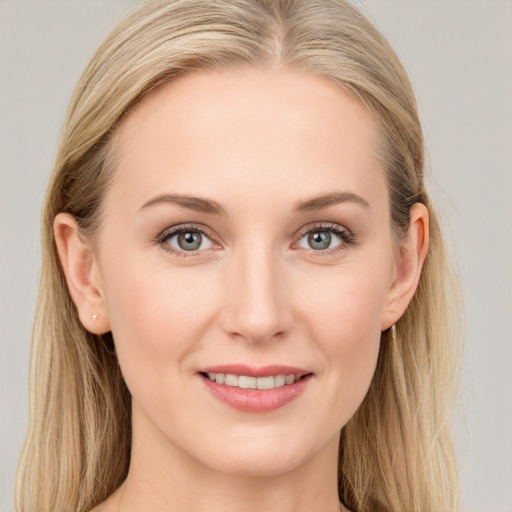 Joyful white young-adult female with long  brown hair and blue eyes