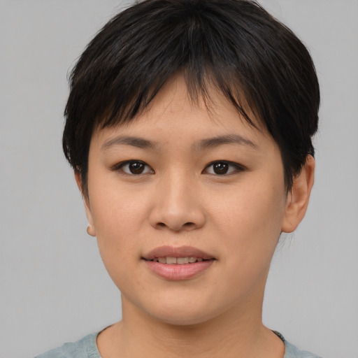 Joyful asian young-adult female with short  brown hair and brown eyes