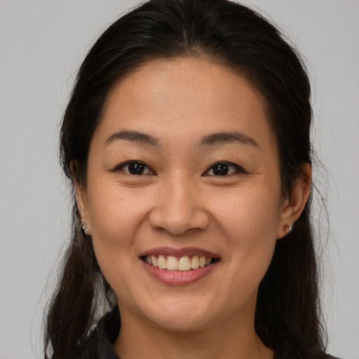 Joyful asian young-adult female with medium  brown hair and brown eyes