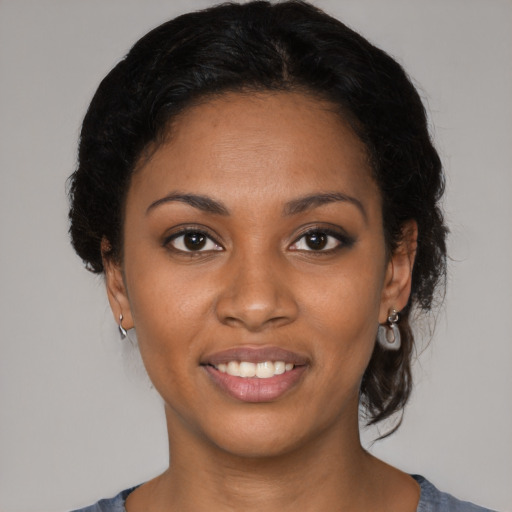 Joyful black young-adult female with medium  brown hair and brown eyes