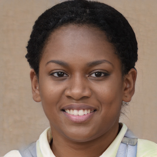 Joyful black young-adult female with short  brown hair and brown eyes