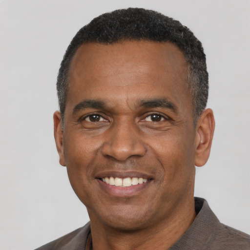 Joyful latino adult male with short  black hair and brown eyes