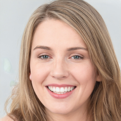 Joyful white young-adult female with long  brown hair and green eyes