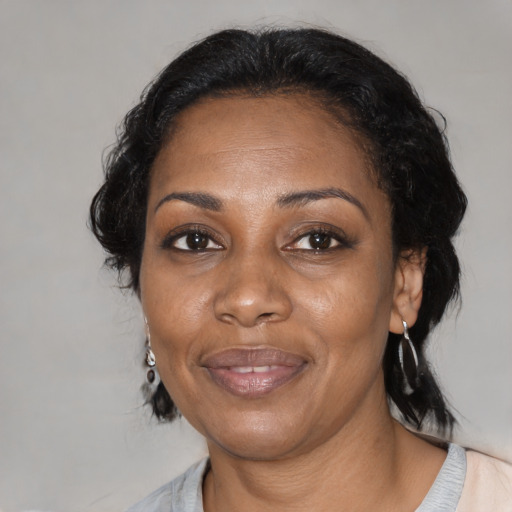 Joyful black adult female with medium  black hair and brown eyes