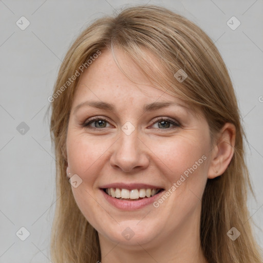 Joyful white adult female with long  brown hair and grey eyes