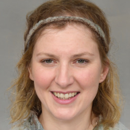 Joyful white young-adult female with medium  brown hair and blue eyes