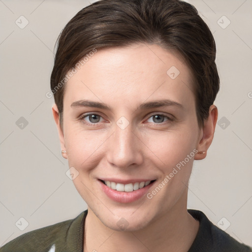 Joyful white young-adult female with short  brown hair and grey eyes