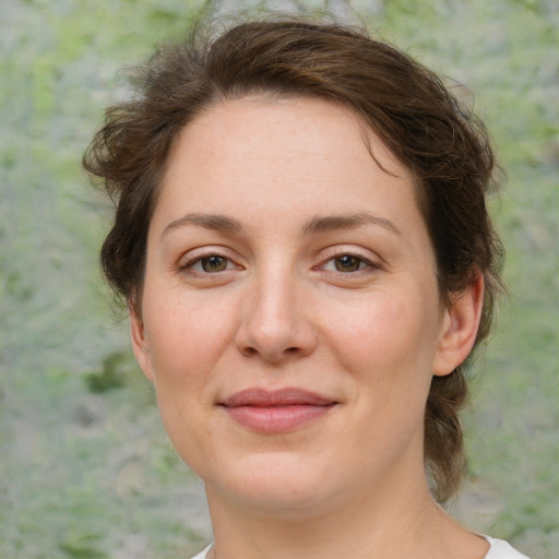 Joyful white adult female with medium  brown hair and green eyes