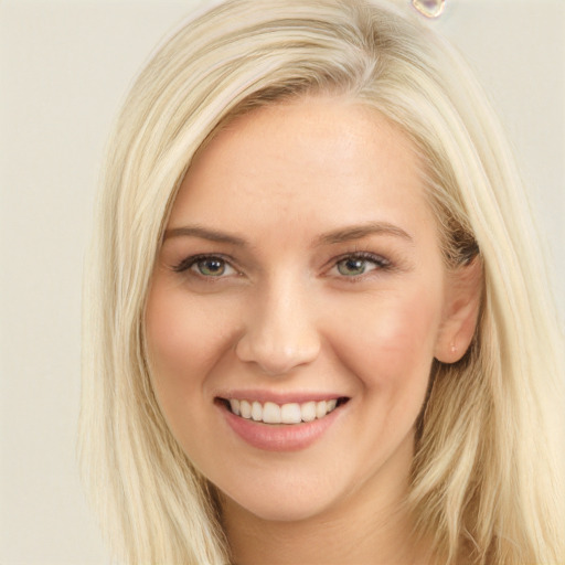 Joyful white young-adult female with long  blond hair and blue eyes