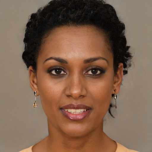 Joyful black young-adult female with short  brown hair and brown eyes