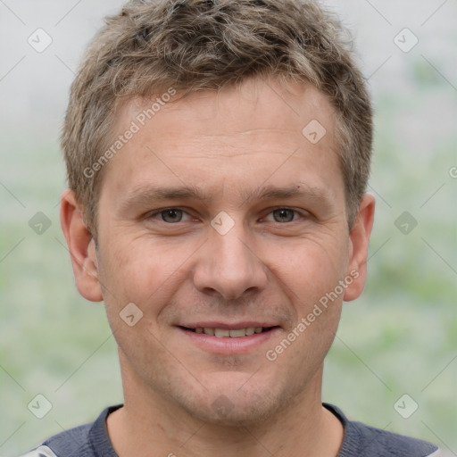 Joyful white adult male with short  brown hair and grey eyes