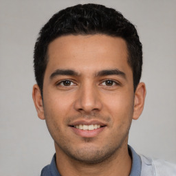 Joyful white young-adult male with short  black hair and brown eyes