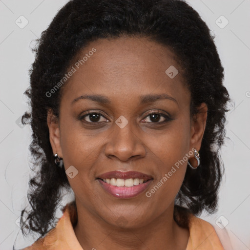 Joyful black adult female with medium  brown hair and brown eyes