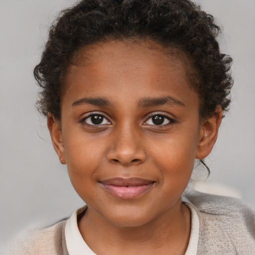 Joyful black child female with short  brown hair and brown eyes