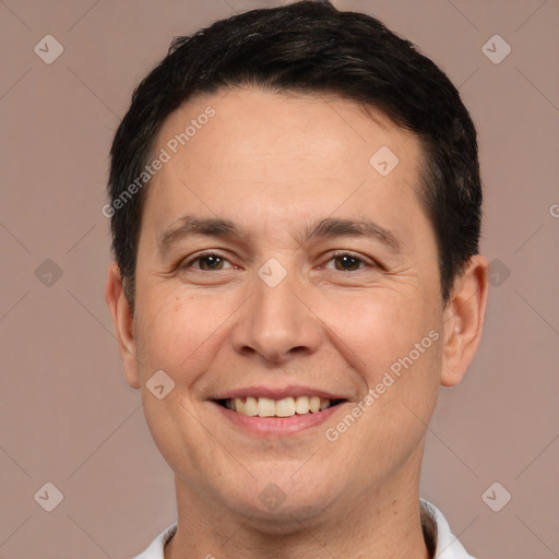 Joyful white adult male with short  brown hair and brown eyes