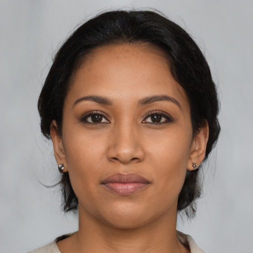 Joyful latino young-adult female with medium  black hair and brown eyes